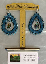 Load image into Gallery viewer, Teardrop abalone teal metallic fish skin earrings. Patina opaque black blue AB, teal mirror 2mm faceted beads, teal faceted stones. On silver hooks