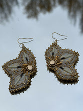 Load image into Gallery viewer, White and metallic gold floral fish skin earrings with porcupine quills. With gold &amp; sheen charlotte cut beads, satin beads, gold bugles, Swarovski crystals. Backed w/ mooseskin and hung on gold hooks.