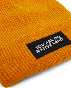 'YOU ARE ON NATIVE LAND' BEANIE - Marigold