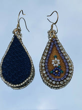 Load image into Gallery viewer, Purple and white flower teardrop moose skin earrings with seed, delica beads and 2 different banding. Backed with purple dyed fish skin. On gold plated hooks.