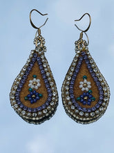 Load image into Gallery viewer, Purple and white flower teardrop moose skin earrings with seed, delica beads and 2 different banding. Backed with purple dyed fish skin. On gold plated hooks.