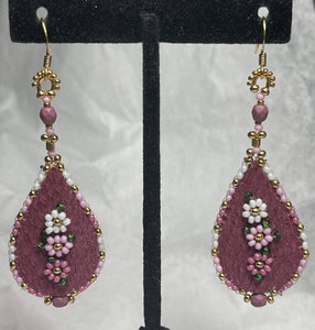 Dyed deep pink fish skin w/flowers in shades of pinks, two sizes 24k gold plated beads, on gold hooks and moose skin backing.