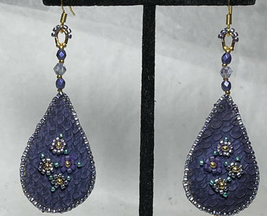 Shades of Purple bouquet teardrop shaped earrings on dyed purple fish skin. 24k size 11 centers with size 15 petals. Japanese crystals. Backed w/moose hide. On gold filled hooks.